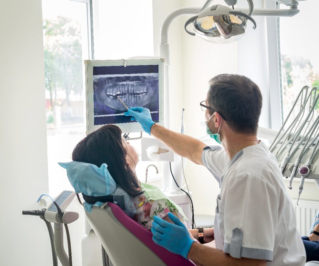 Doctor dentist showing patients teeth on x ray jpg
