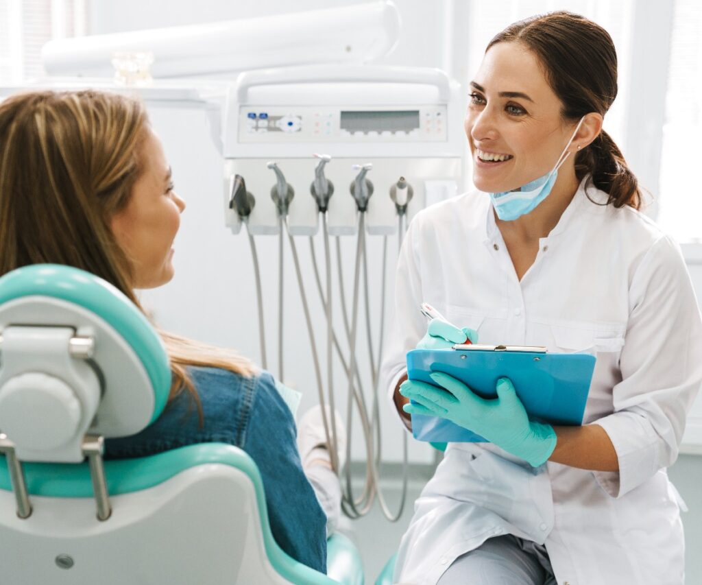 European mid dentist woman smiling while working with patient jpg