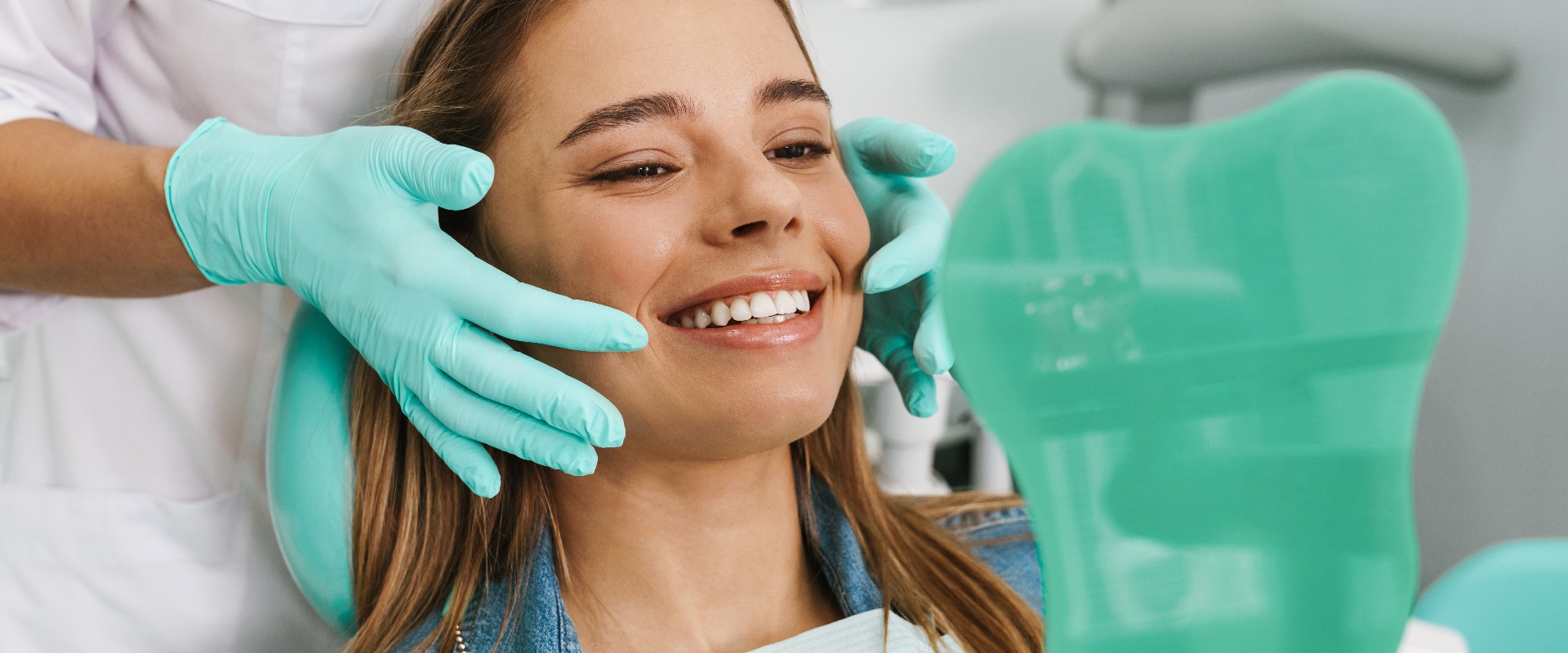 European young woman smiling while looking at mirror in dental clinic jpg