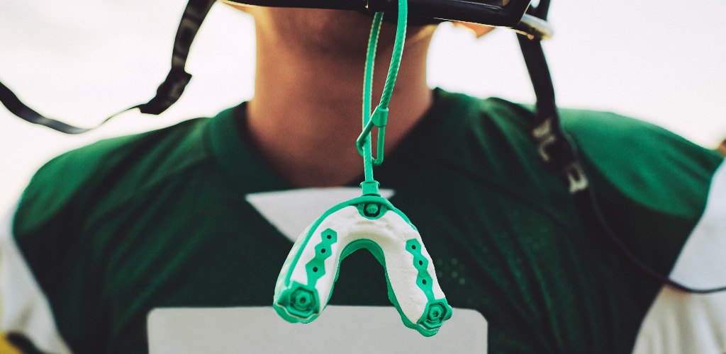 Mouthguard hanging off the helmet of an american football player jpg